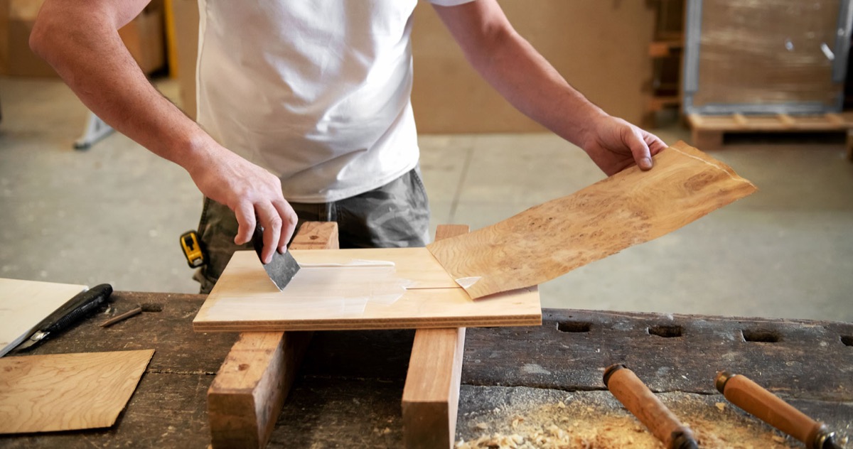 Applying wood veneer in a workshop