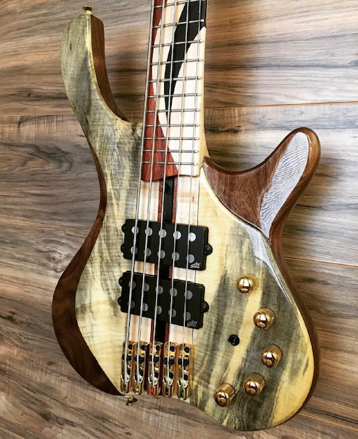Five-string bass guitar with a spalted figured maple top and walnut wings